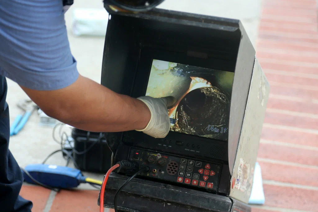 Technician viewing a drain inspection camera in Estero